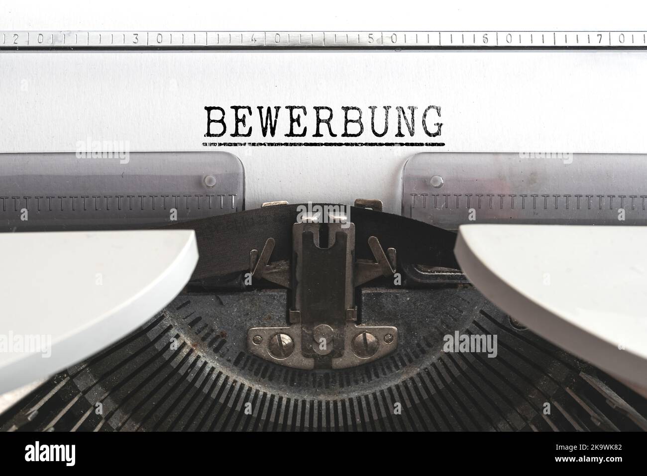 close-up view of word BEWERBUNG, German for job application, written on old mechanical typewriter Stock Photo