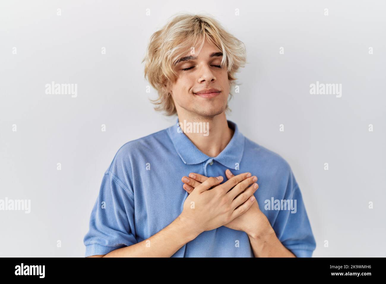 Young modern man standing over isolated background smiling with hands ...