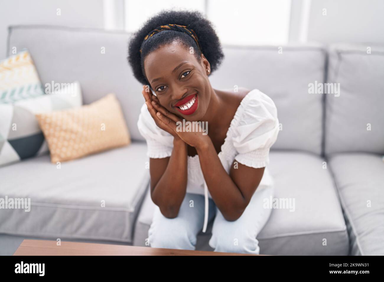 African american woman smiling confident sitting on sofa at home Stock ...