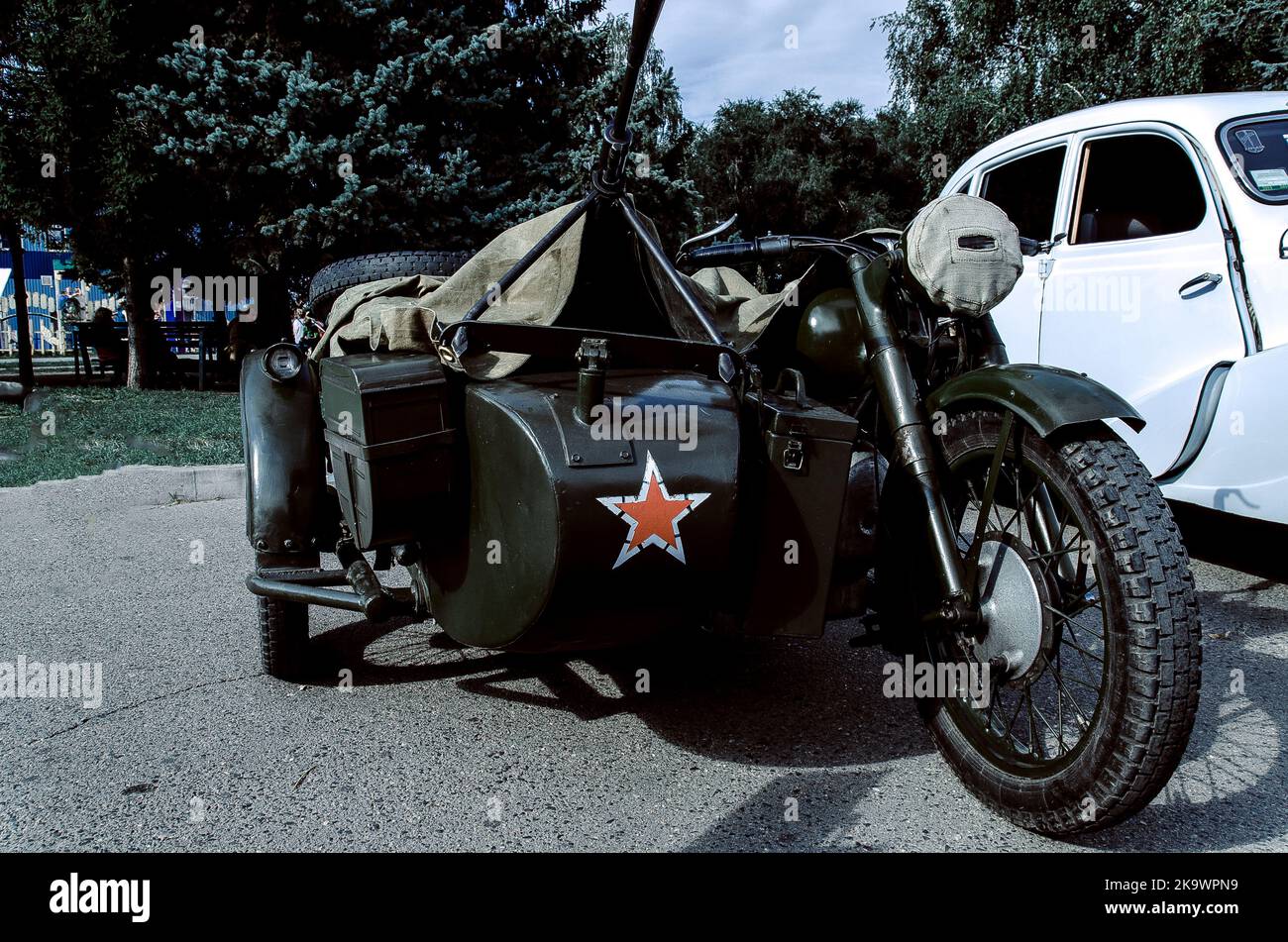 Old Tricar, Three-Wheeled Gray Motorcycle With A Sidecar Of German Forces Of World War 2 Time. Stock Photo