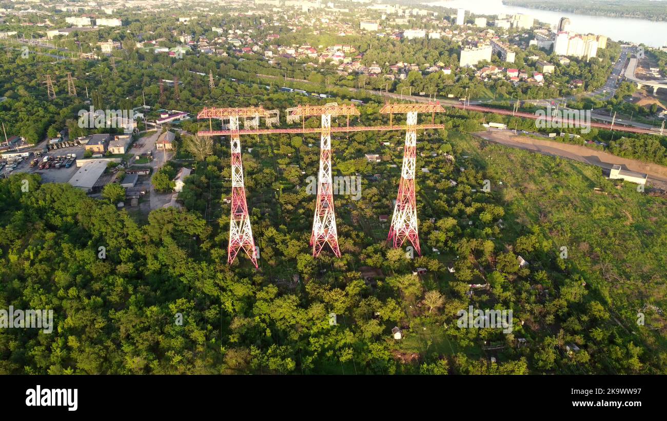 High voltage post. Three High voltage towers. Group of transmission towers or power tower, electricity pylon, steel lattice tower. Aerial view Stock Photo