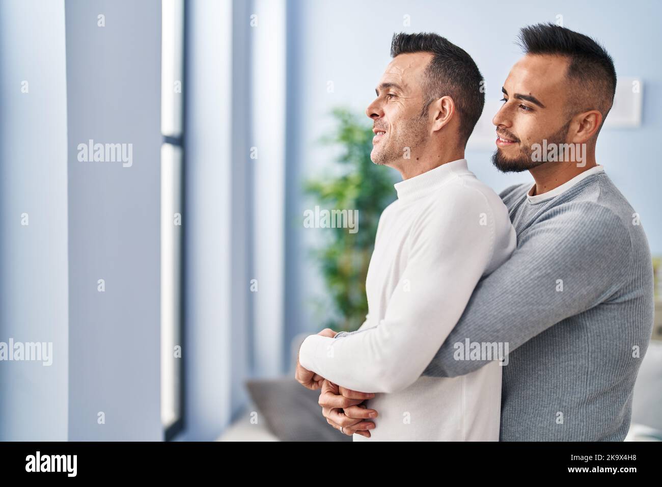 Two men couple hugging each other standing at home Stock Photo - Alamy