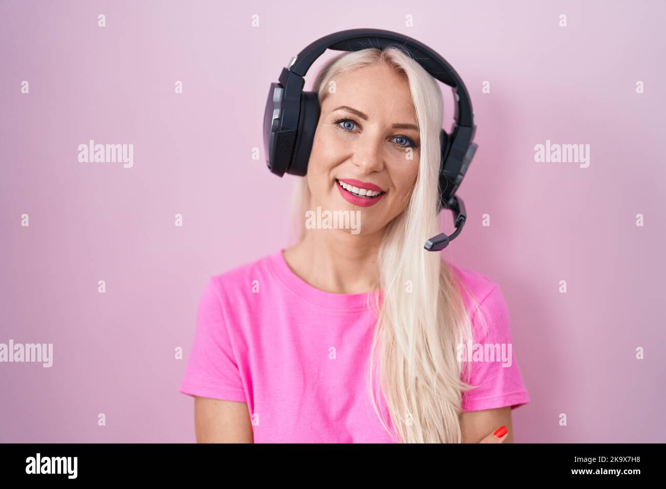 Caucasian woman listening to music using headphones happy face smiling ...