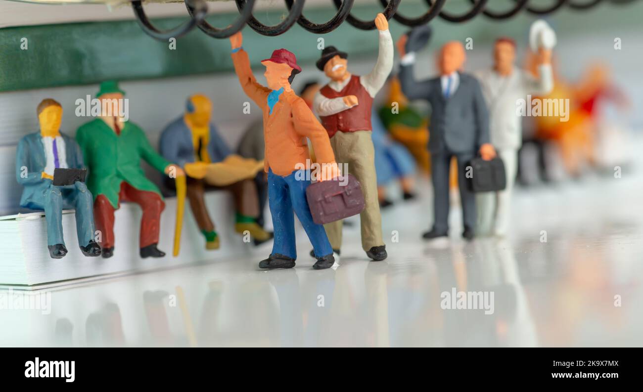 Miniature toy of people travelling on a public transport concept - train or bus. Stock Photo