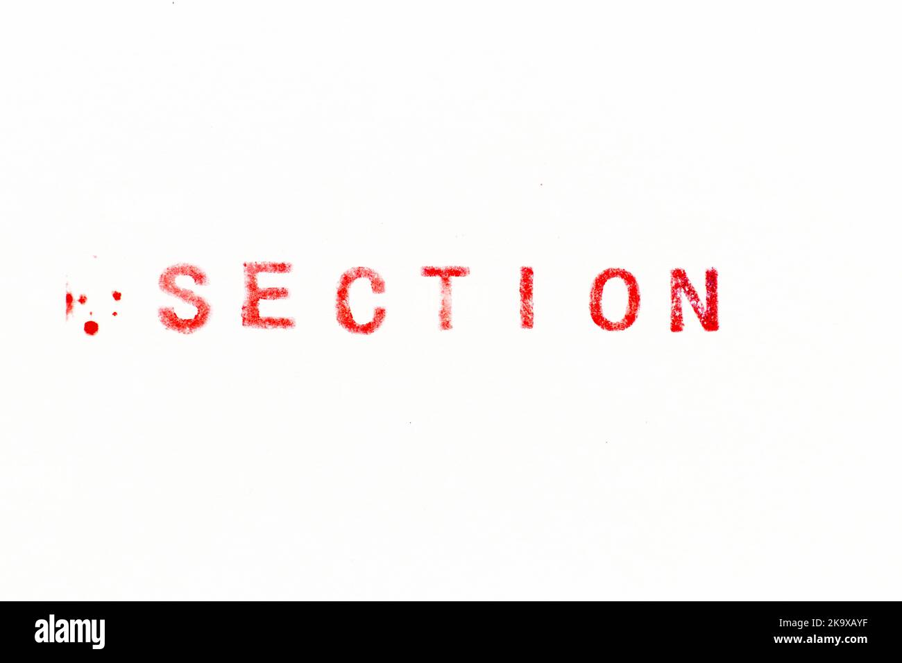 Red color ink rubber stamp in word section on white paper background