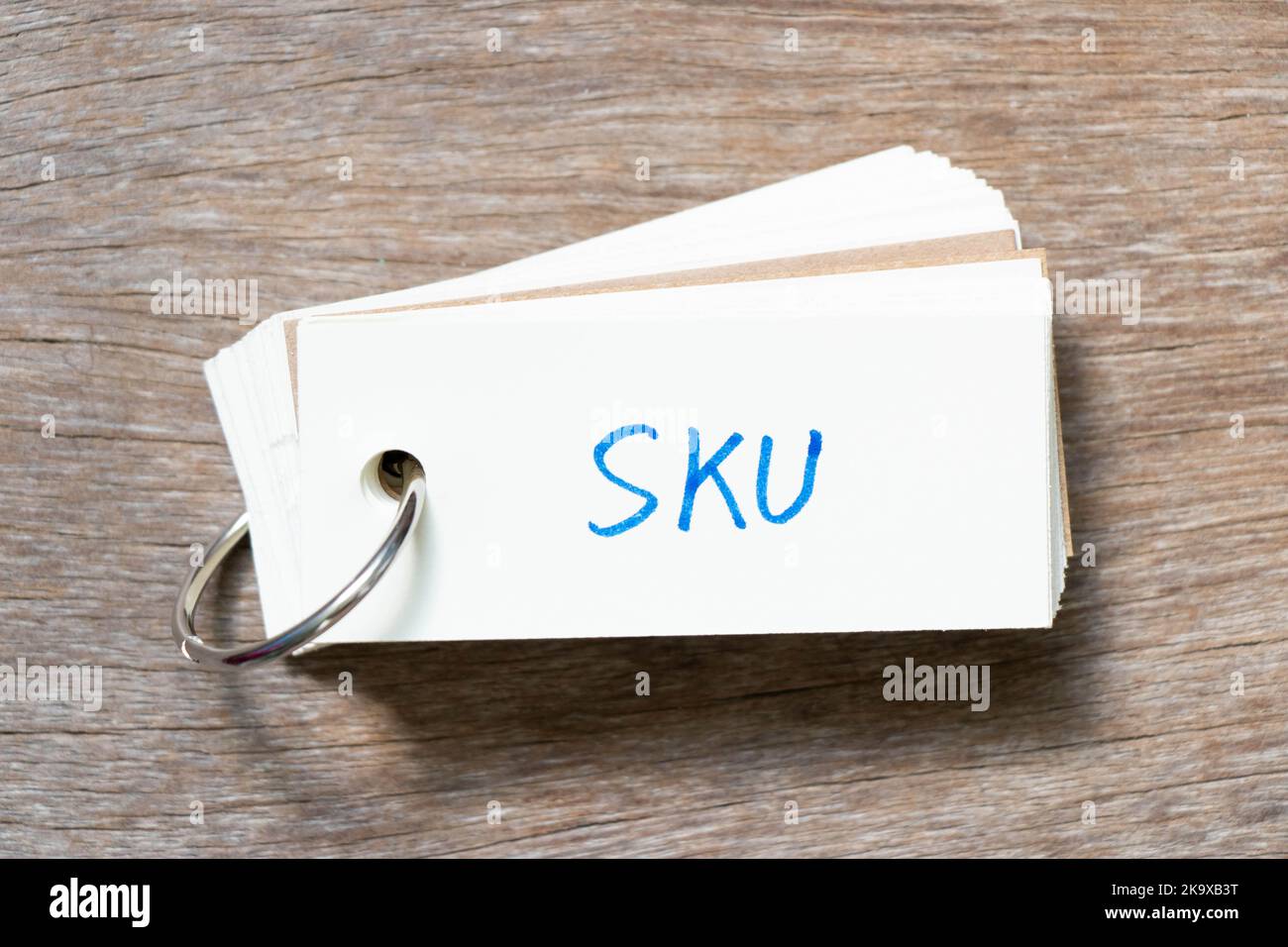 Flash card with handwriting in word SKU (Abbreviation of stock keeping