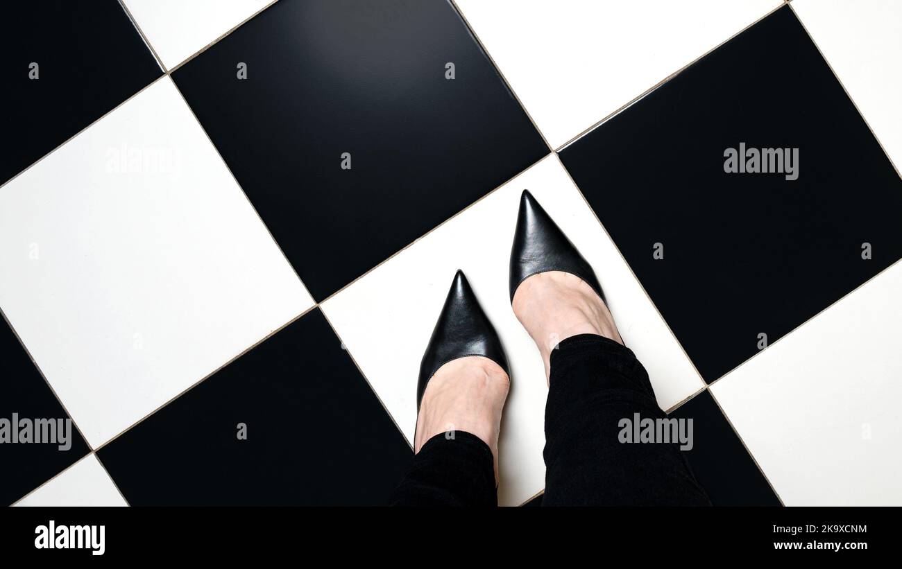 Selfie feet with classic shoes court shoe on chequered floor background