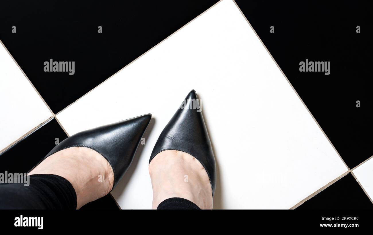 Selfie feet with classic shoes court shoe on chequered floor background