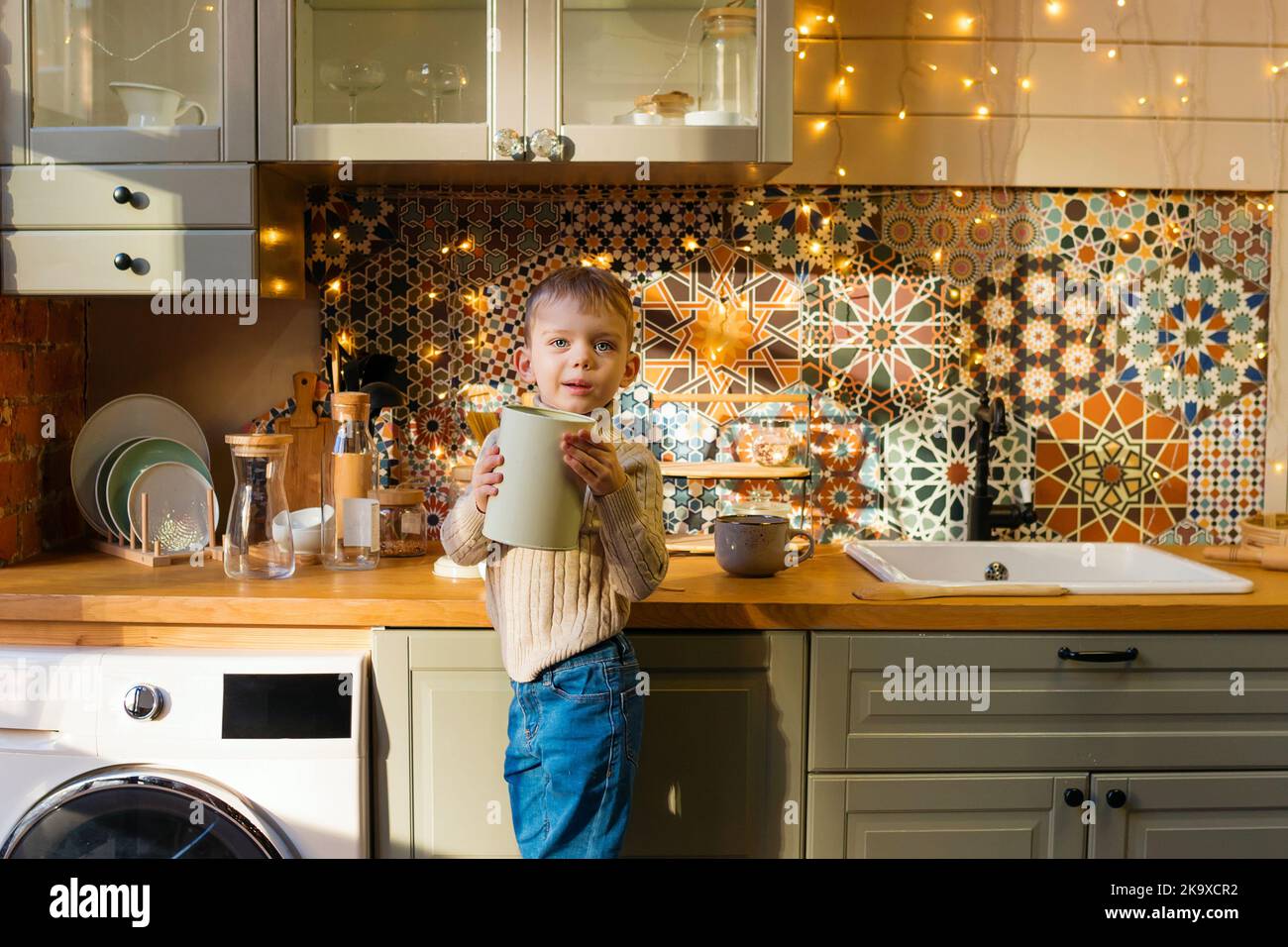 Little kid helper in kitchen. Child boy 3 years old posing in kitchen ...