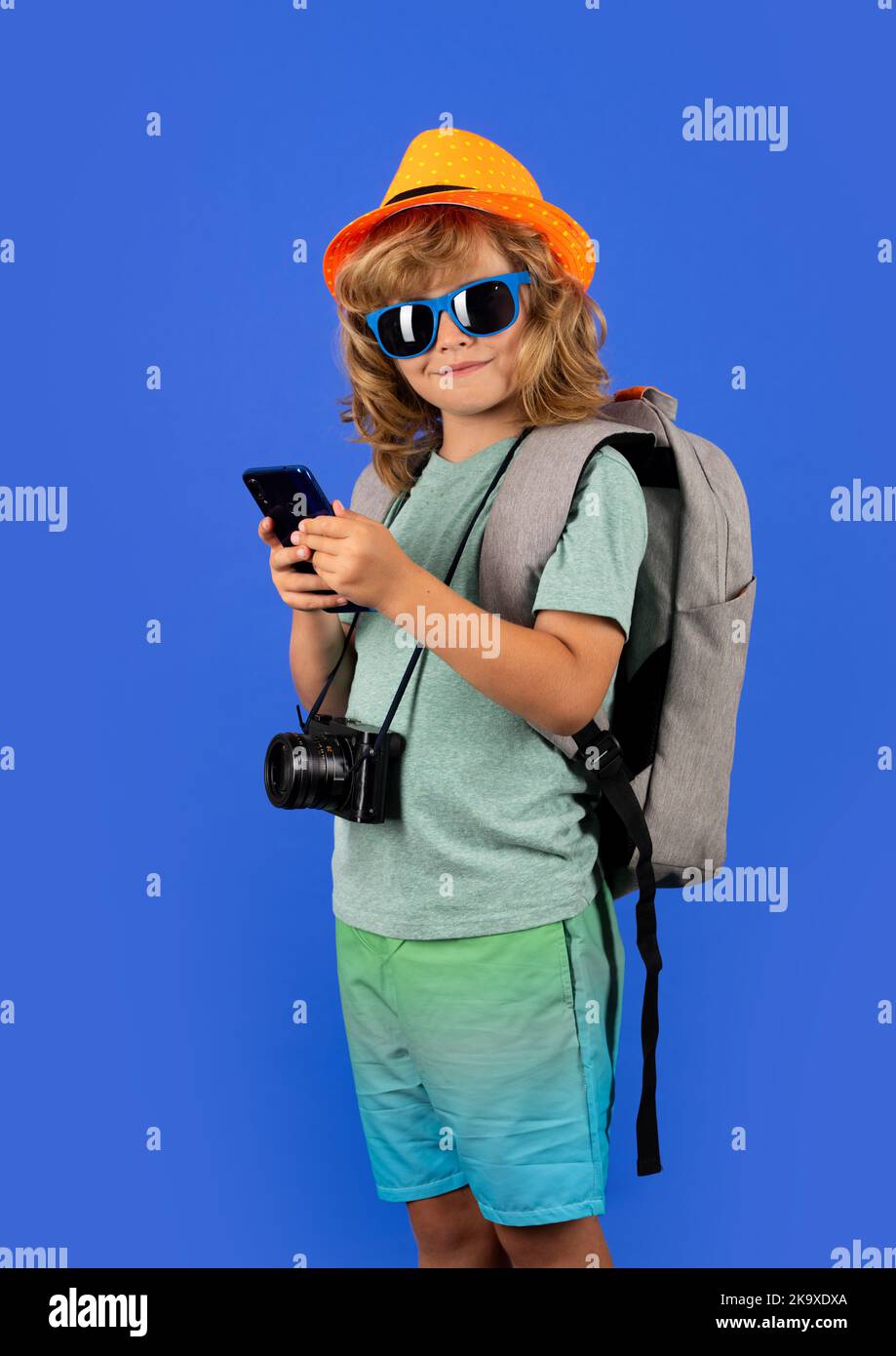 Traveler tourist kid boy 7-8 years old. Kid boy with mobile phone. Stock Photo