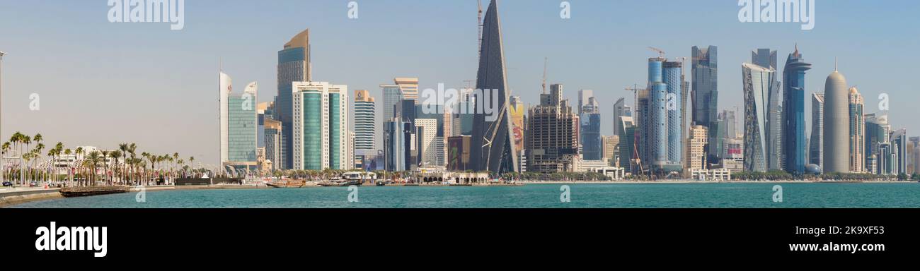 The skyline of modern and high-rising city of Doha in Qatar. Panorama shot of Doha Corniche. Stock Photo