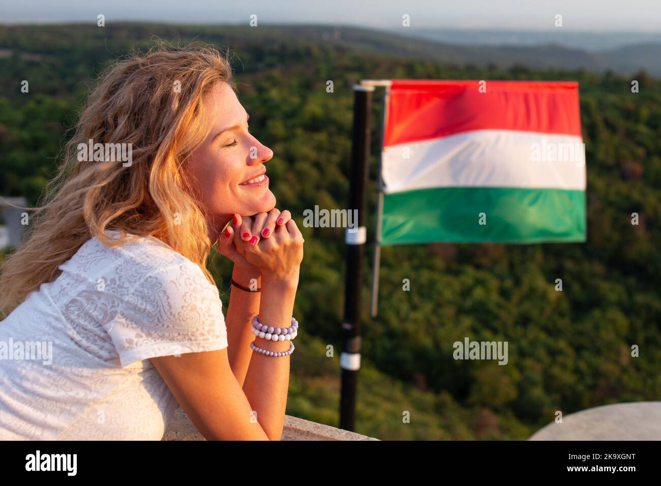 Young cheerful Caucasian woman relaxing in nature eyes closed, at
