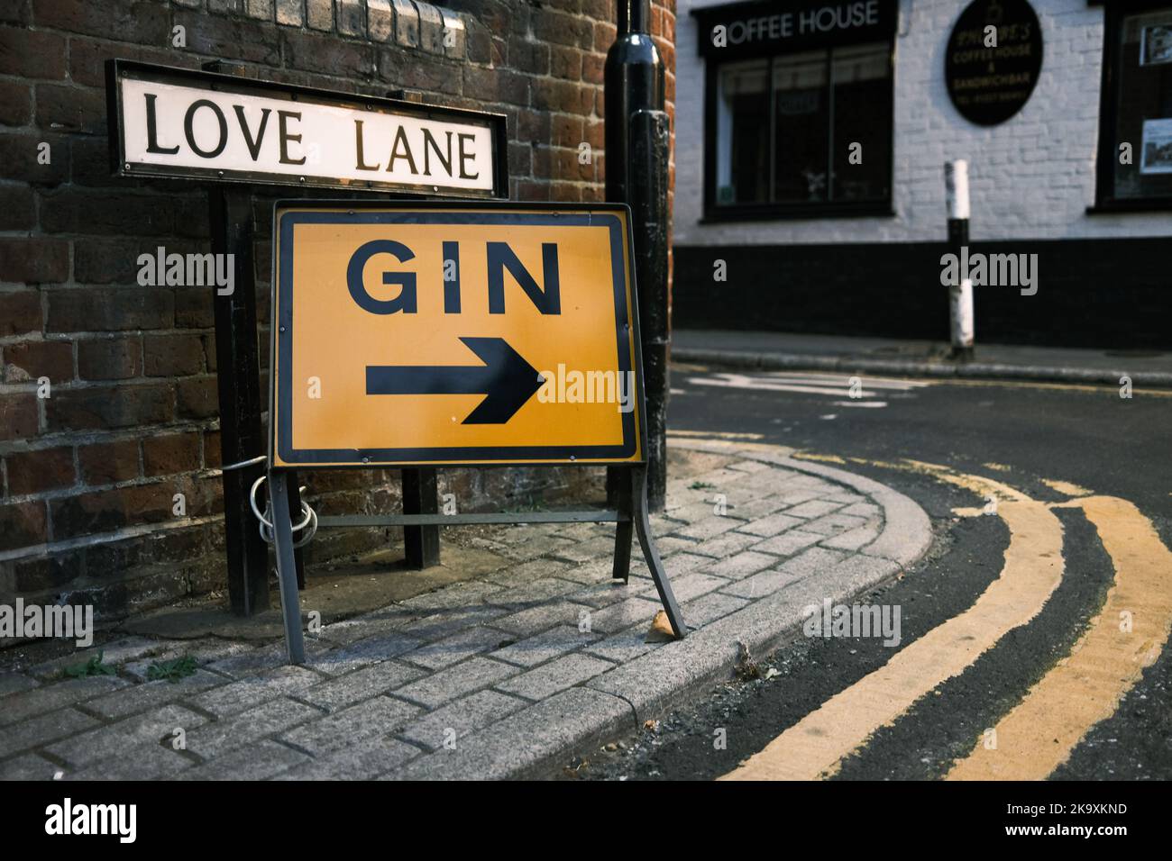Sign for 'Gin' Pointing to a Local Pub, Canterbury, Kent, UK Stock Photo