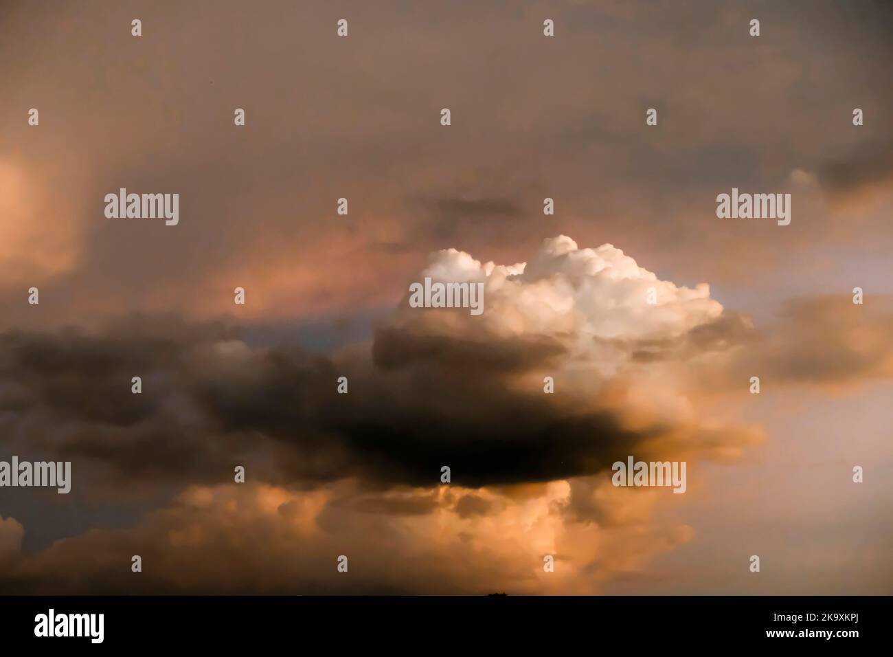 Dramatic threatening sky clouds sunset after tropical rain thunder storm Stock Photo
