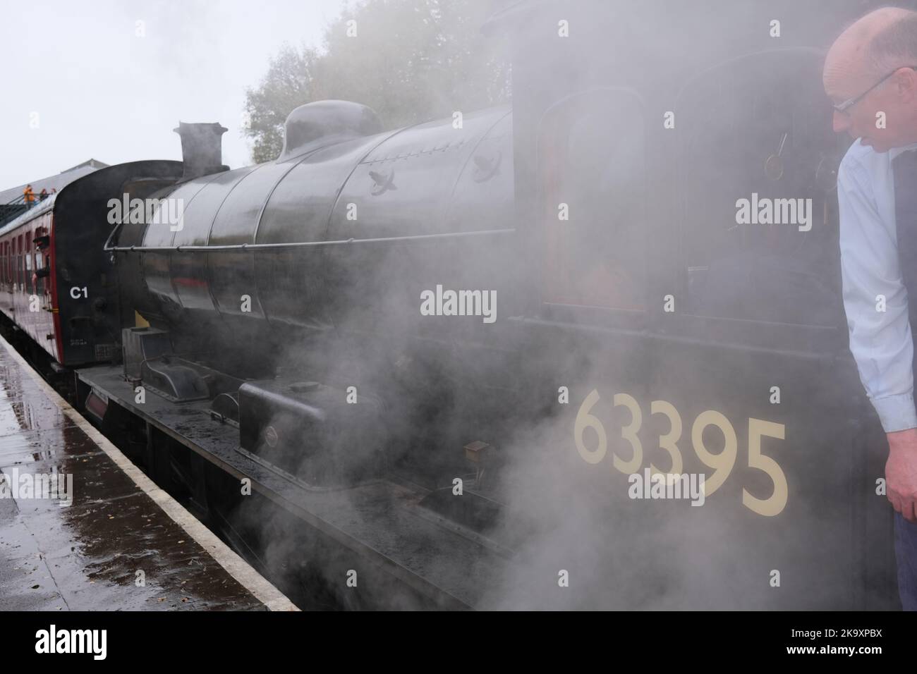 Driver in Steam engine 63395 on Pickering Railway station, North Yorkshire Moors railway Stock