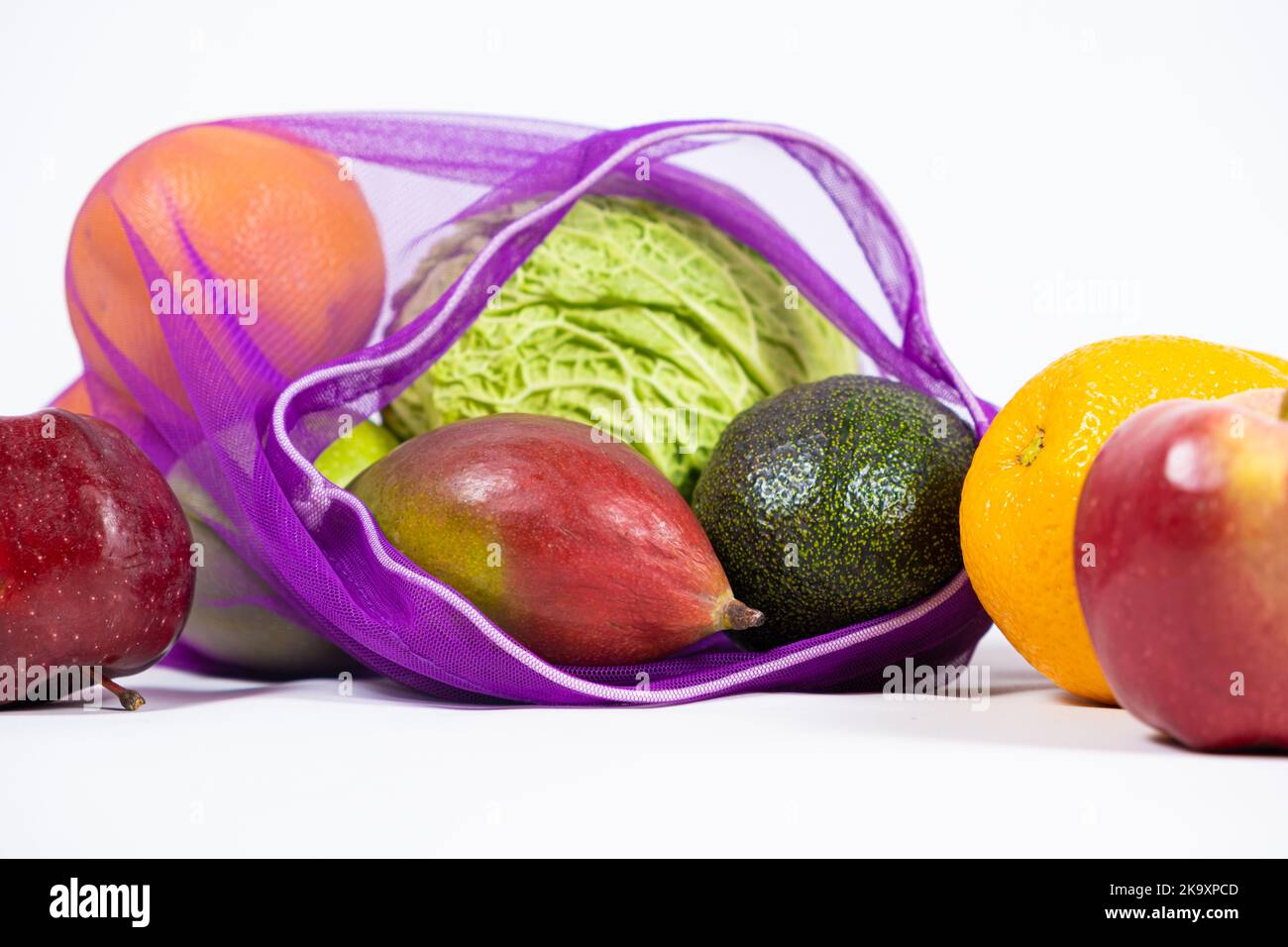 Fabric mesh for fruits and vegetables on a white background. A reusable
