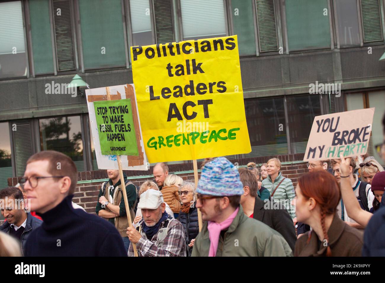 A sign reads Politicians talk Leaders ACT. The people s Climate March to support action on global climate change. Copenhagen, Denmark - October 30, 20 Stock Photo