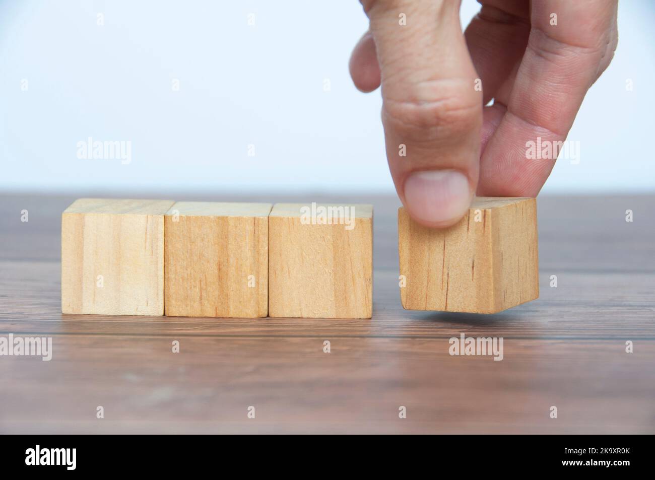 Hand turning blank wooden cubes customizable space for text or ideas