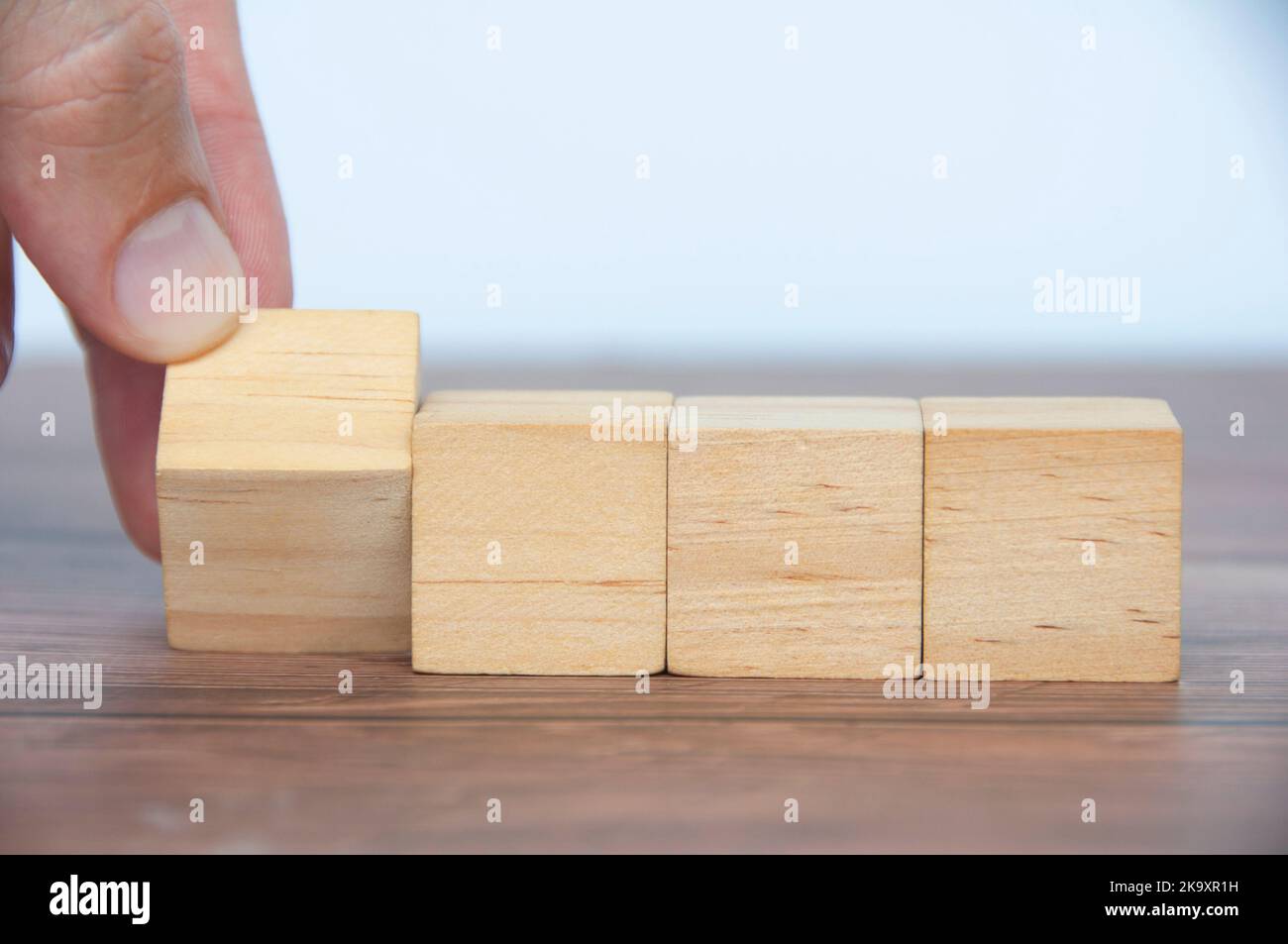 Hand turning blank wooden cubes customizable space for text or ideas