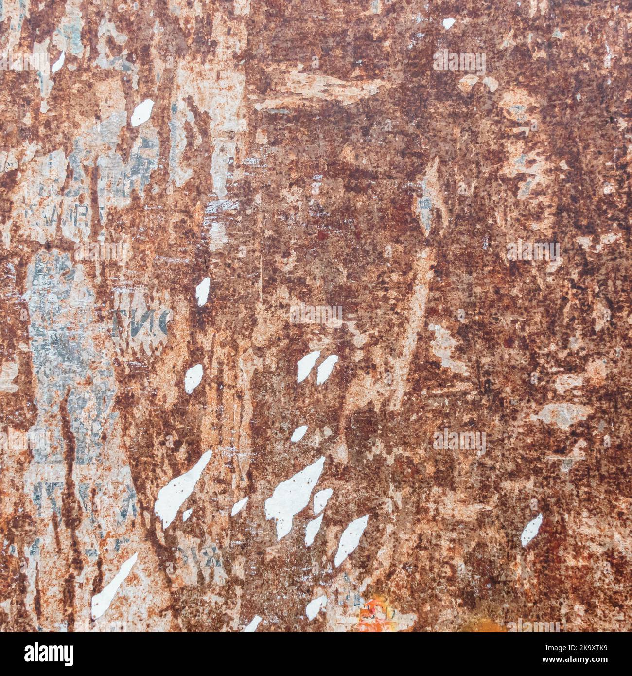 Rusted metal background, with torn pieces of paper. Stock Photo