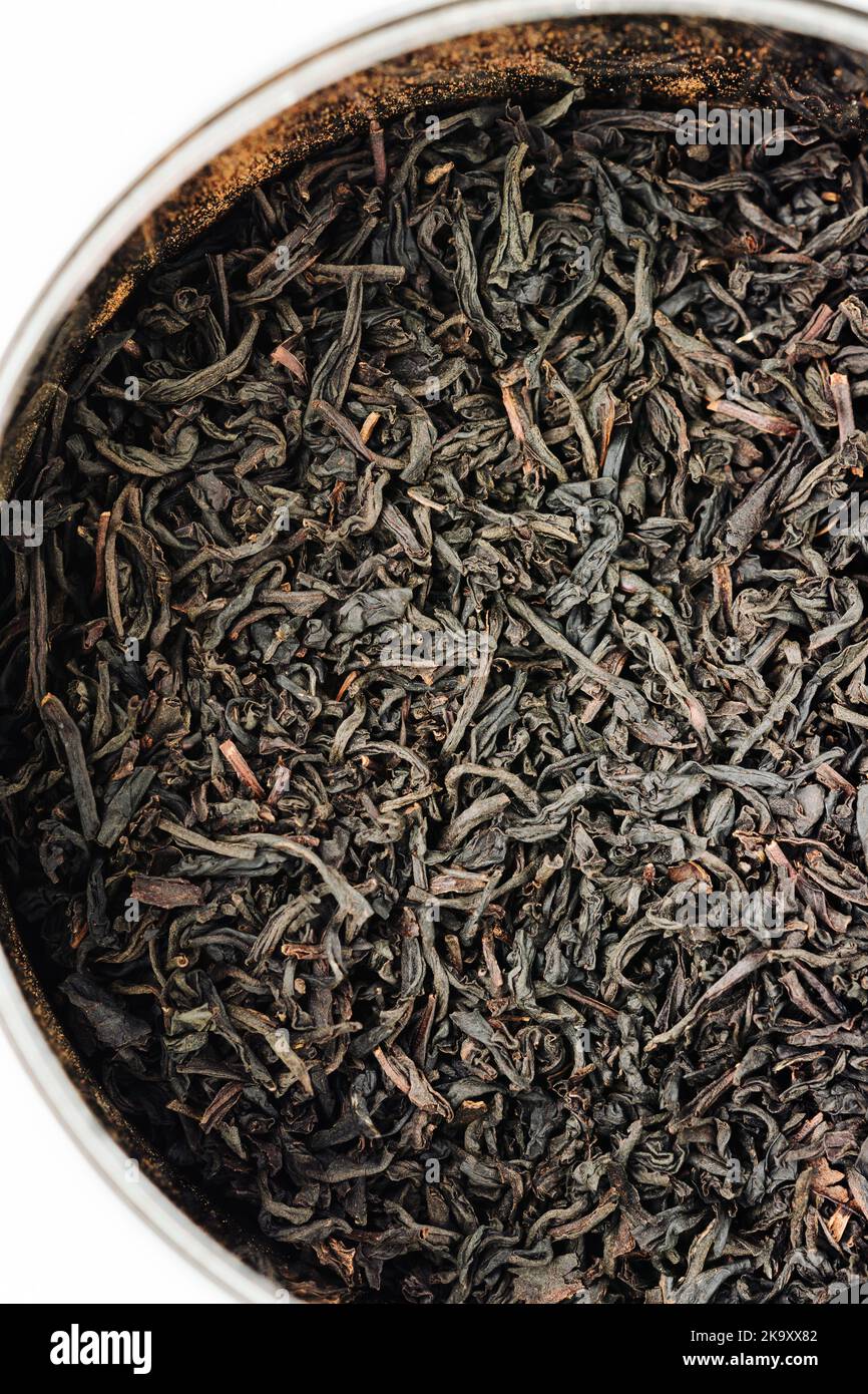 Dry black tea leaves in a jar, close-up. Stock Photo