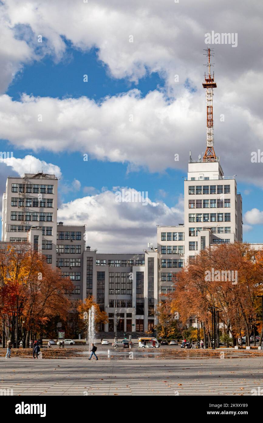 Autumn colorful city architecture. Derzhprom historic constructivist building with fountain on Freedom or Svobody Square with epic clouds in Kharkiv, Stock Photo