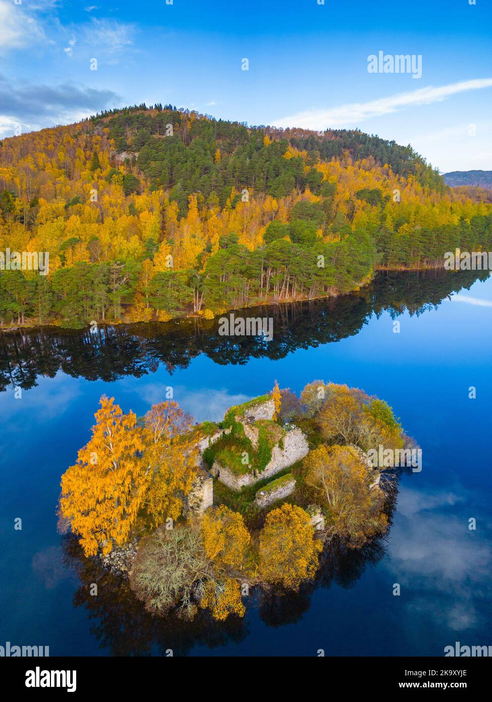 Aerial view of autumn colours at ruined castle on island on Loch an Eilein in Rothiemurchus estate, Cairngorms National Park near Aviemore Stock Photo