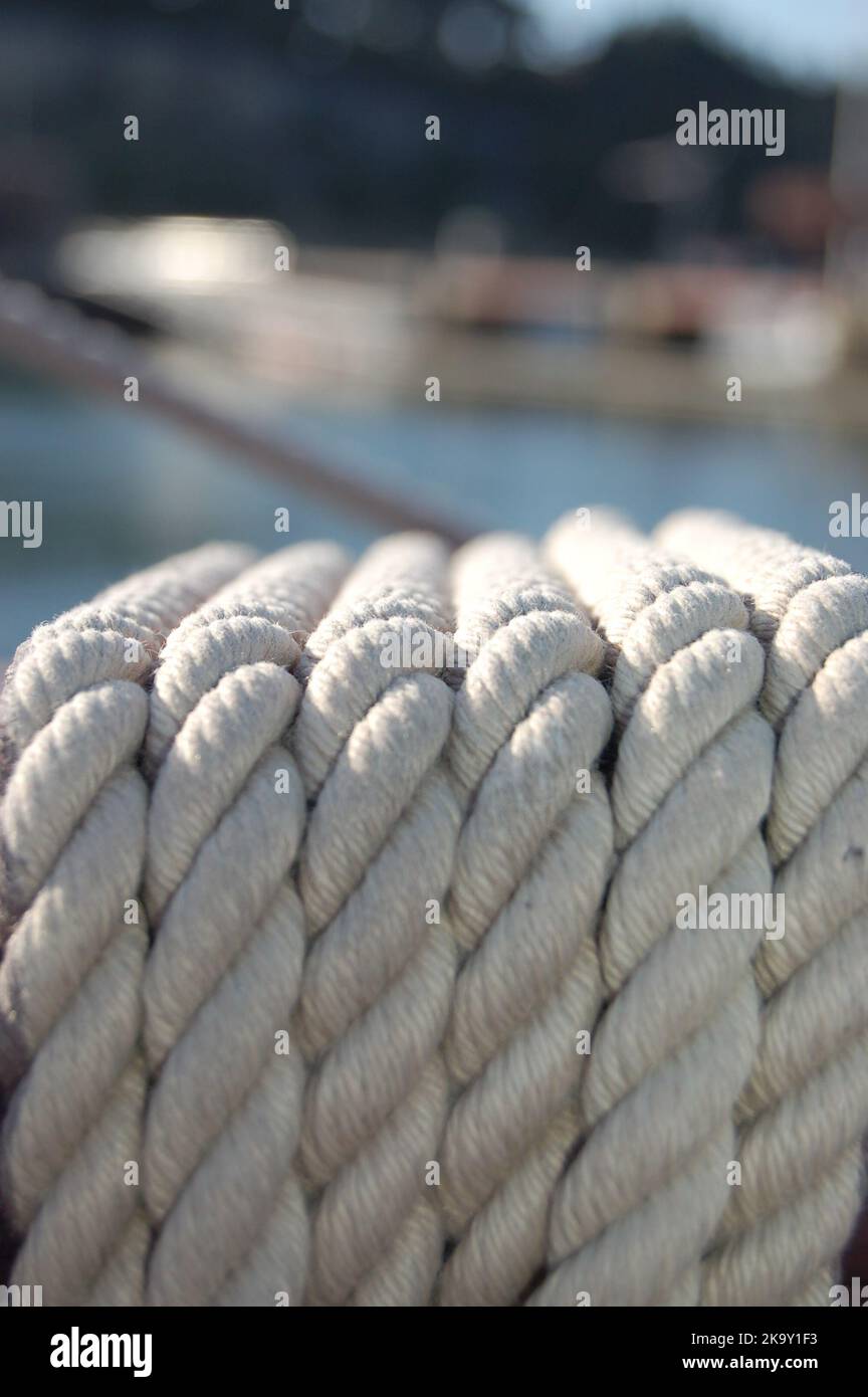 Yellow rope pile closeup photo. Ship or rock climbing tackle. Natural material woven cordage. Simple rope bulk concept. Alpine mountaineering Stock Photo