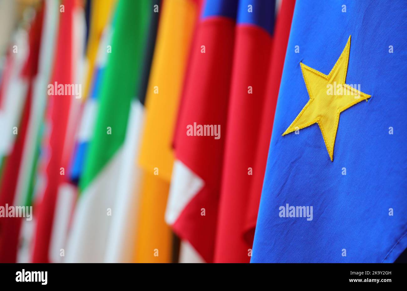 Yellow star of the European flag and in the background the other flags of Europe Stock Photo Alamy