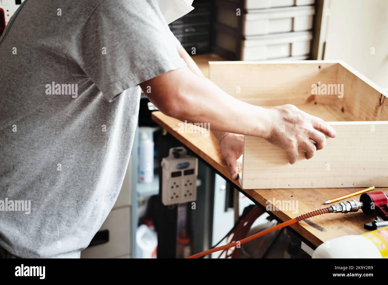 A carpenter measures the planks to assemble the parts, and build a