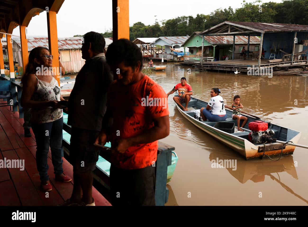 People wait to cast their votes at a polling station set up in a floating school, in the Catalao community, in Iranduba, Amazonas state, Brazil October 30, 2022. REUTERS/Bruno Kelly Stock Photo