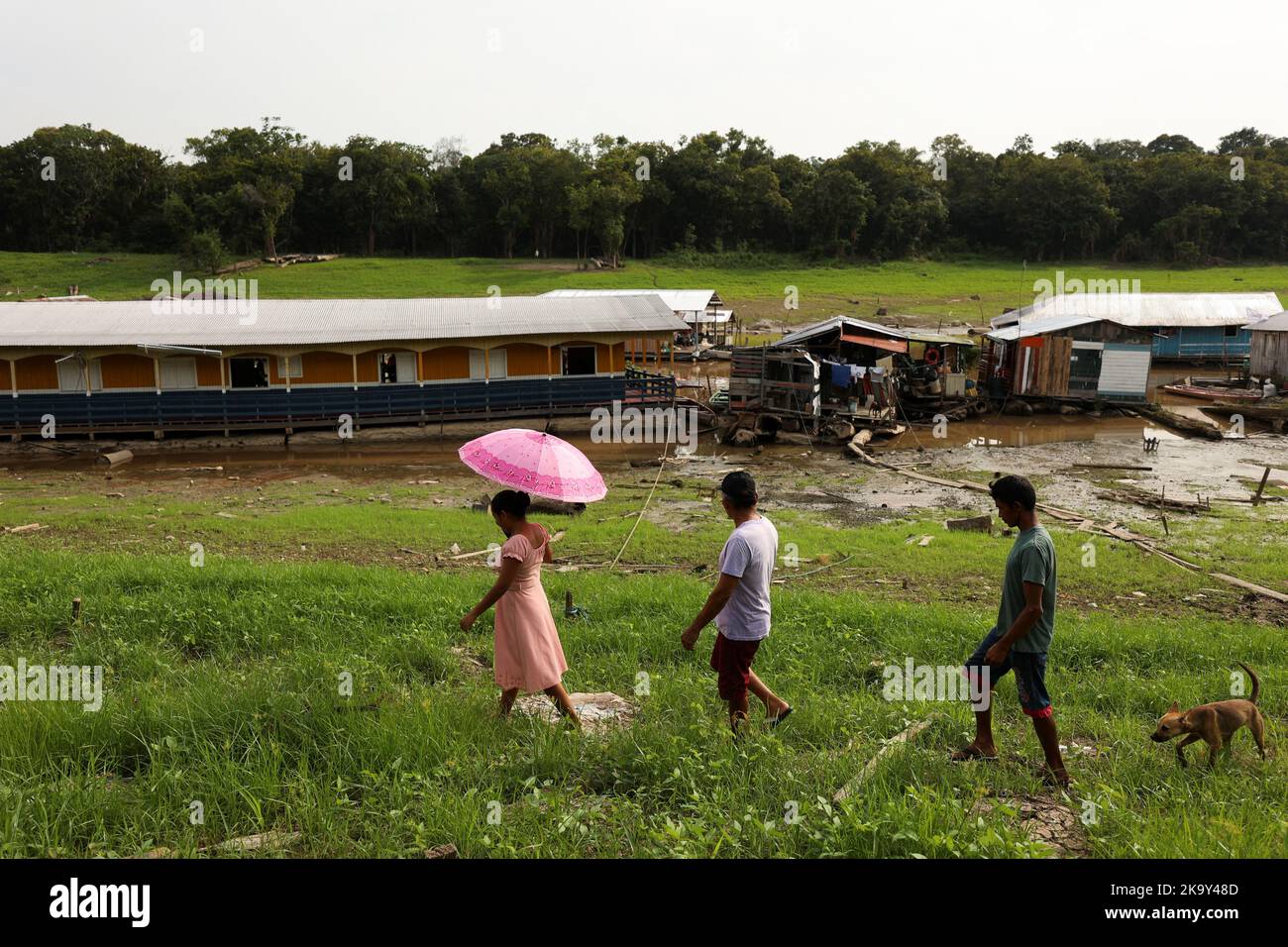 People walk to cast their votes at a polling station set up in a floating school, in the Catalao community, in Iranduba, Amazonas state, Brazil October 30, 2022. REUTERS/Bruno Kelly Stock Photo