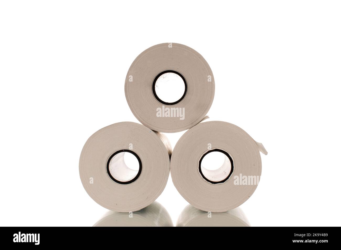 Three rolls of paper cash register tape, closeup isolated on white