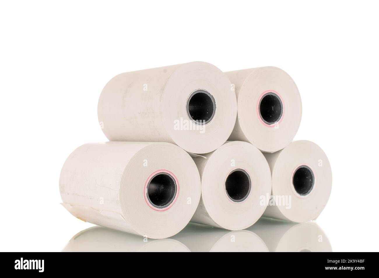 Several rolls of paper cash register tape, closeup isolated on white