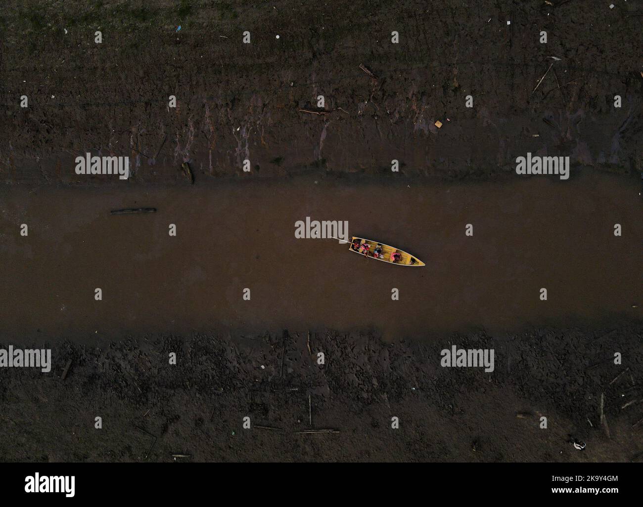 People ride in a boat in the shallow Negro river to cast their votes at a polling station, in the Catalao community, in Iranduba, Amazonas state, Brazil October 30, 2022. REUTERS/Bruno Kelly Stock Photo