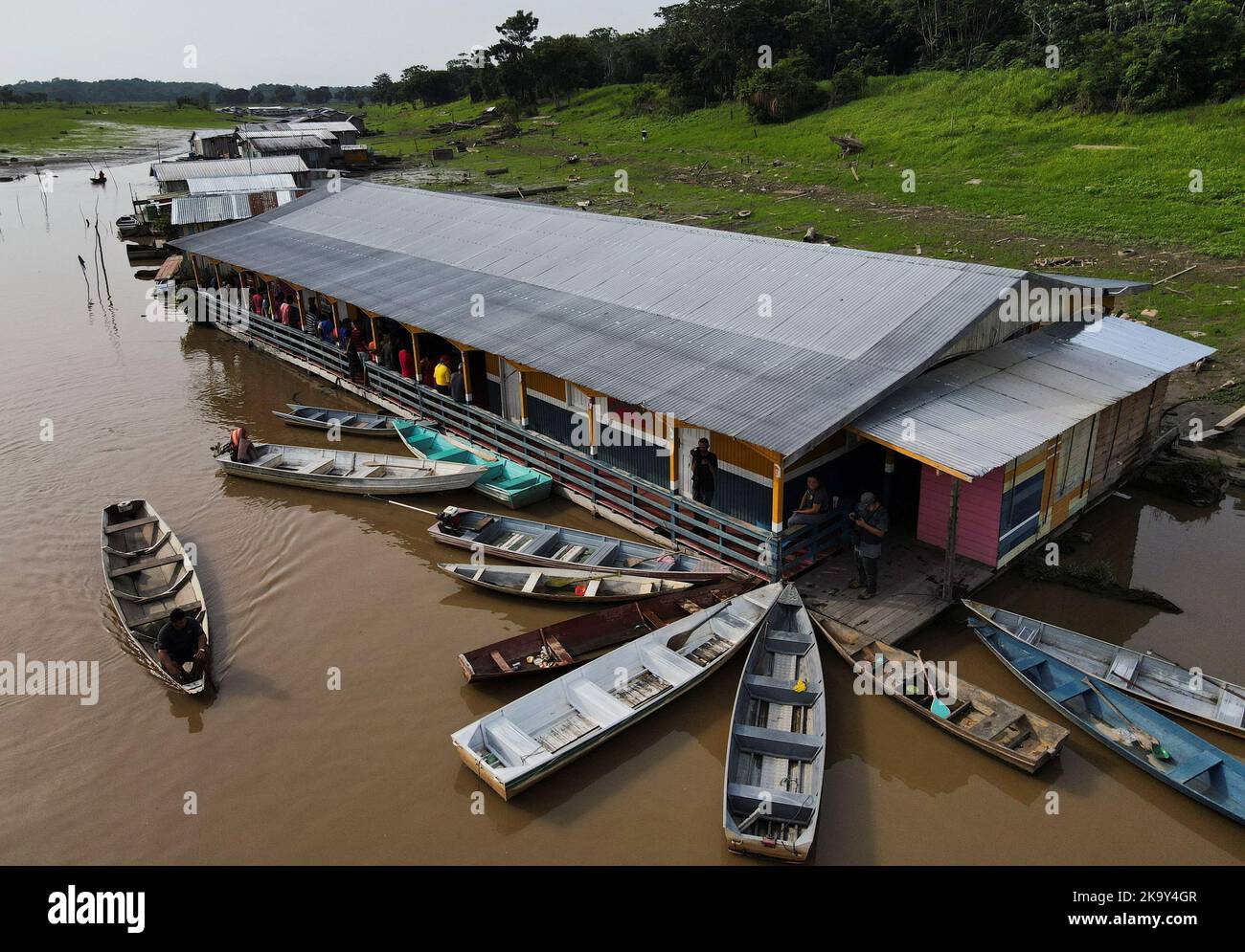 People stand in line to cast their votes at a polling station set up in a floating school, in the Catalao community, in Iranduba, Amazonas state, Brazil October 30, 2022. REUTERS/Bruno Kelly Stock Photo