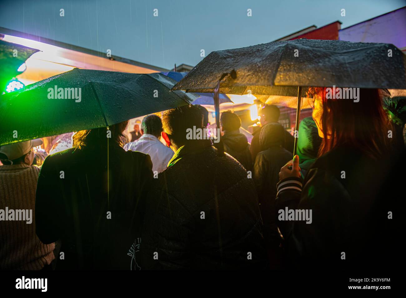 Umbrellas raised in heavy rain at Tooting's celebration of Divali, London. Stock Photo