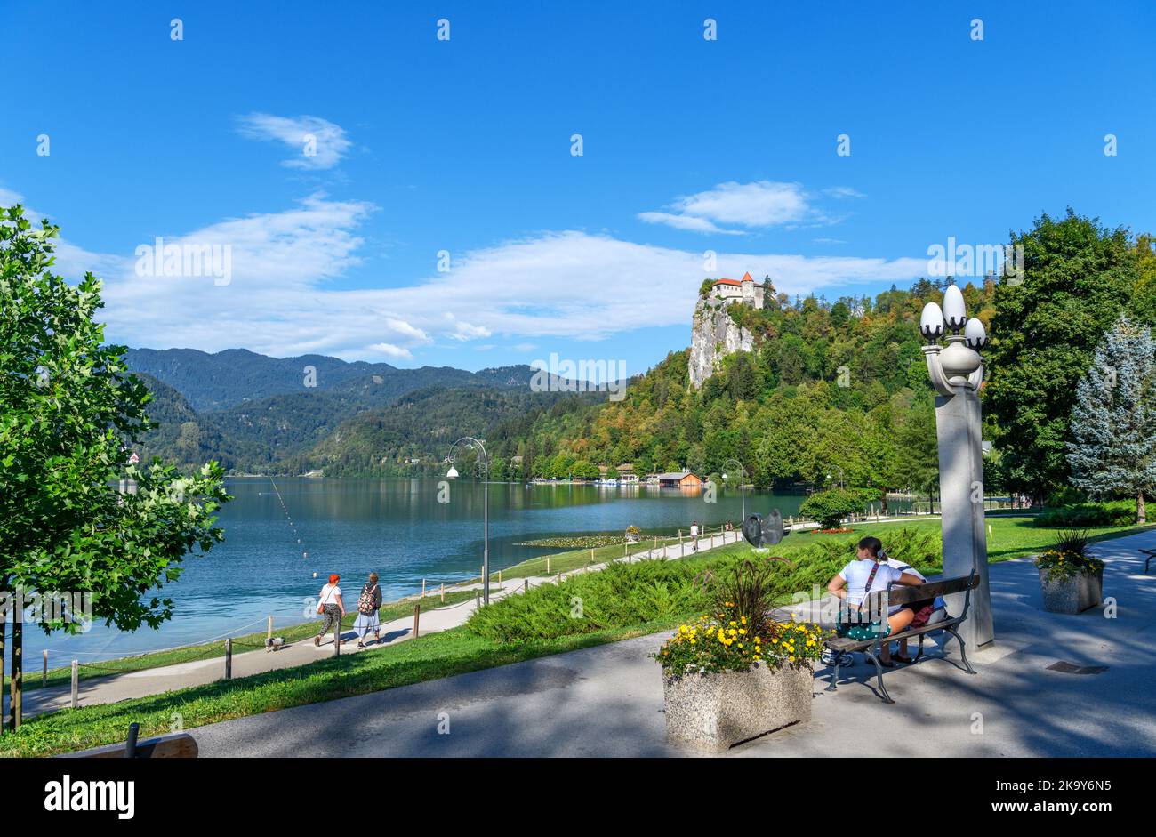 View along the lakefront towards Bled Castle, Bled village, Lake Bled, Slovenia Stock Photo