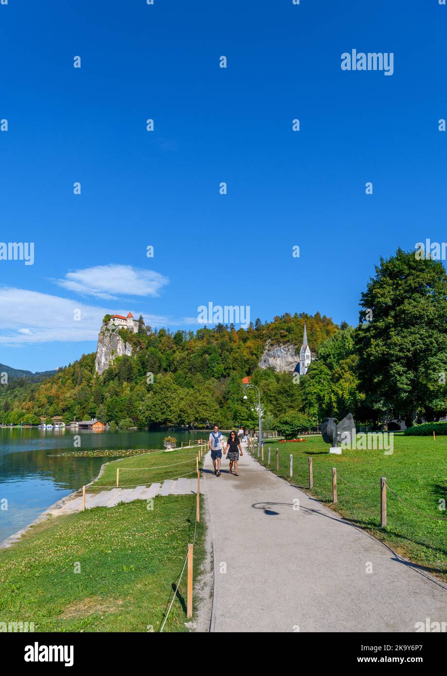 View along the lakefront towards Bled Castle, Bled village, Lake Bled, Slovenia Stock Photo
