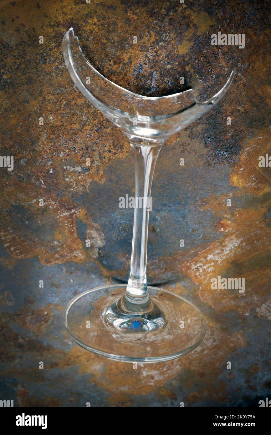 broken wine glass on rusting tin tray Stock Photo