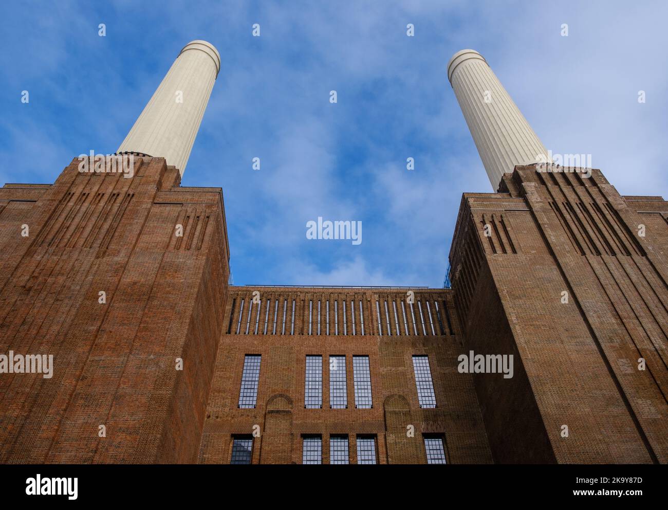 Two reconstructed chimneys of iconic Grade II* listed Battersea Power Station against a blue sky. Stock Photo