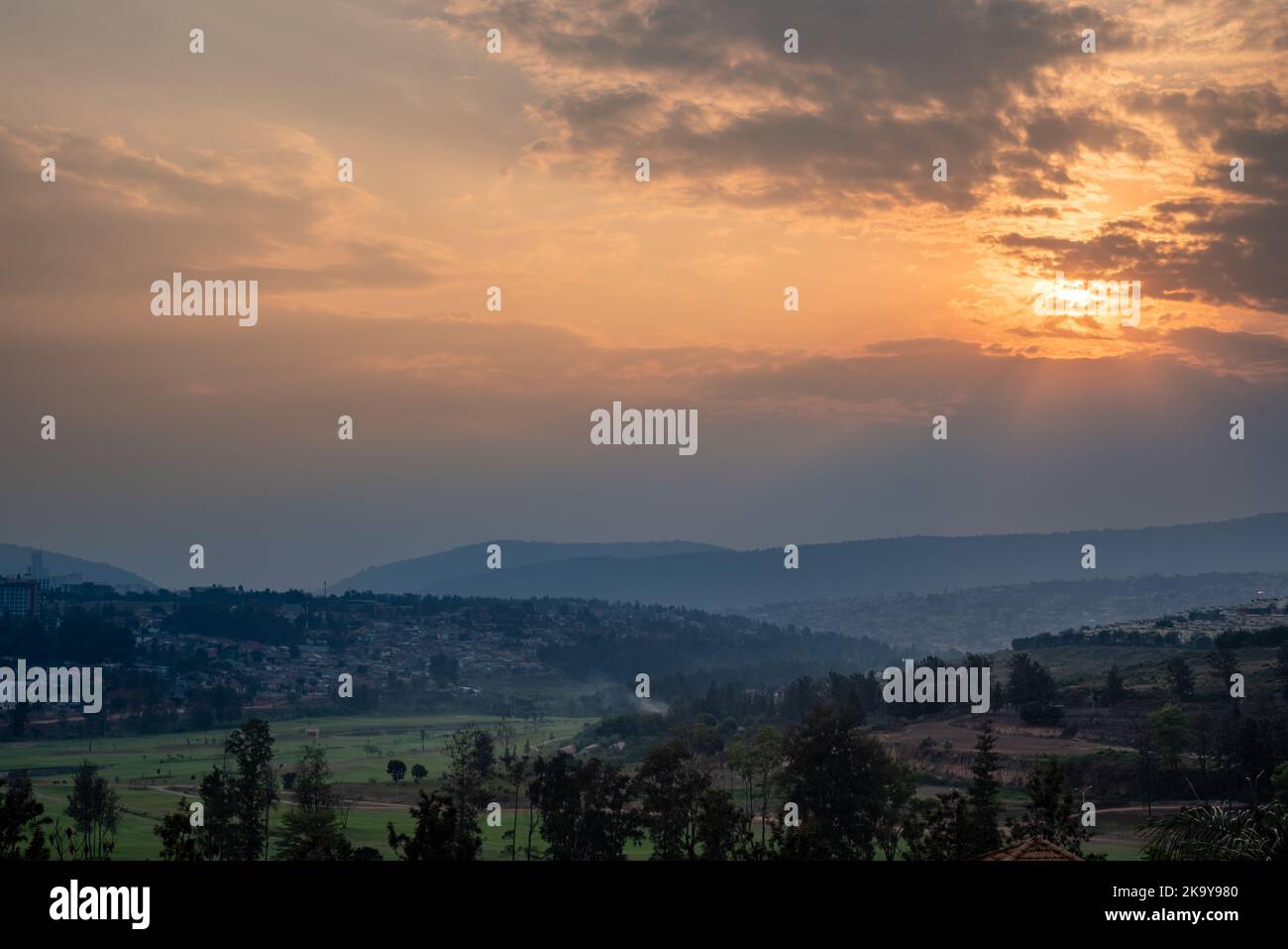 A view of the sun setting over the hills in Kigali, Rwanda Stock Photo