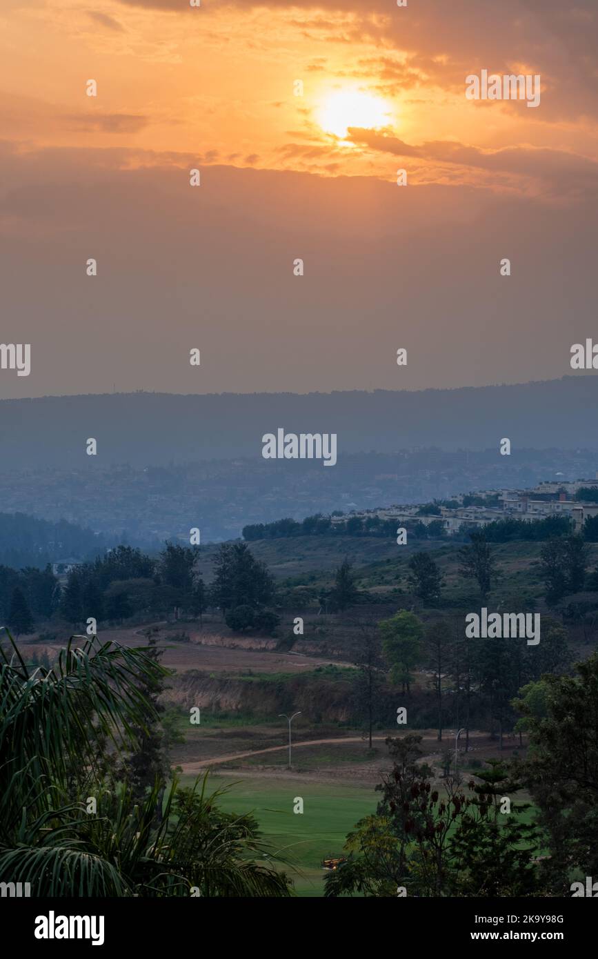 A view of the sun setting over the hills in Kigali, Rwanda Stock Photo