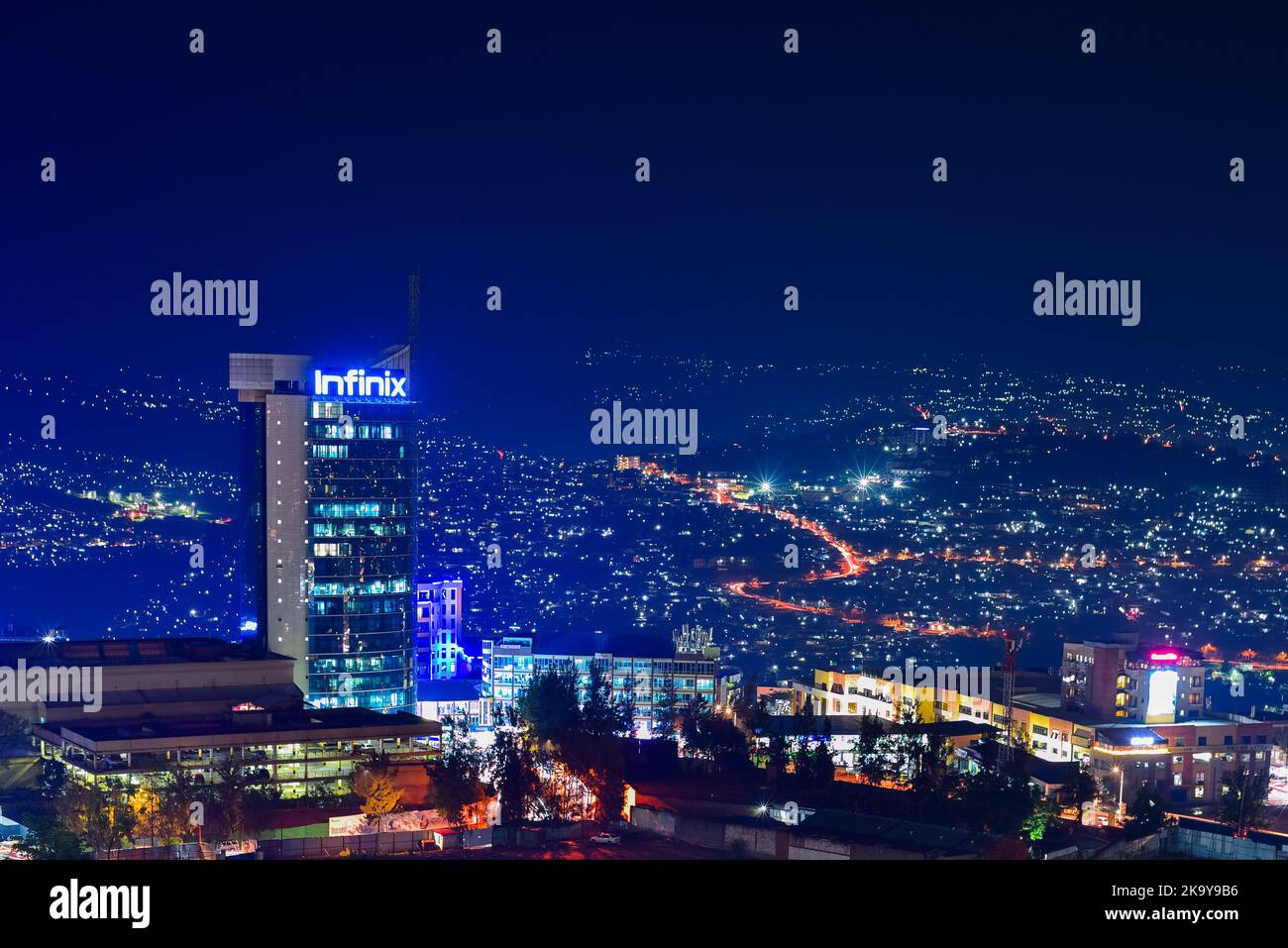 Kigali, Rwanda - August 17 2022: Night shot of Kigali City Tower in the town centre against the backdrop of hills. Stock Photo