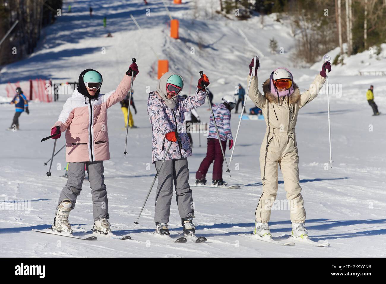 Young girls of skiers on the ski slope have fun Stock Photo