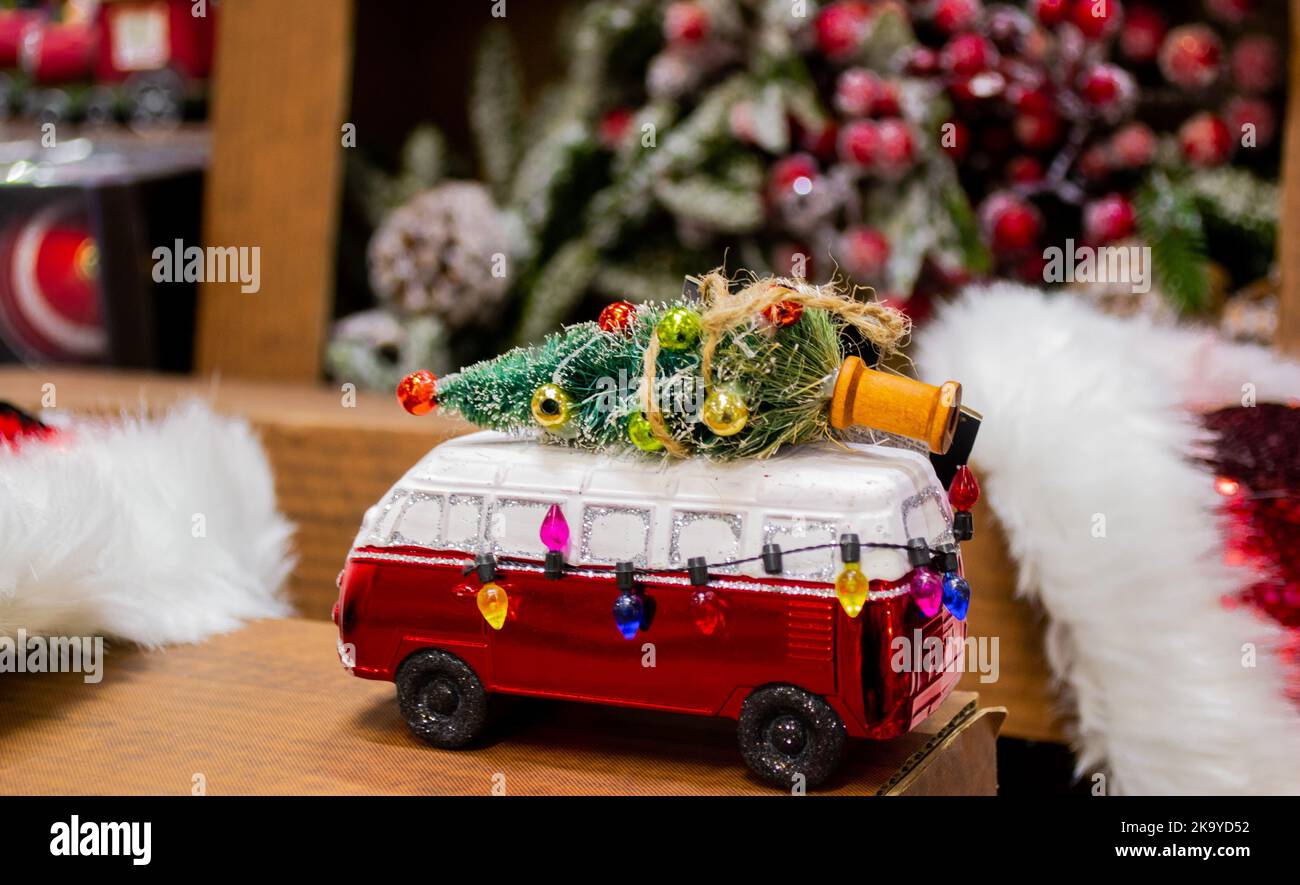 Retro style Christmas decorations in the form of a red bus with a decorated Christmas tree in the roof. Stock Photo