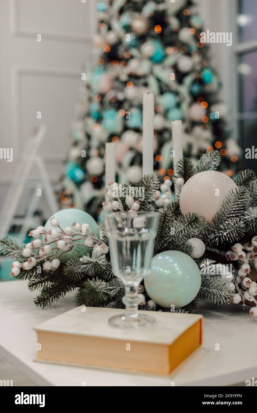 The glass on the book in the living room. Christmas interior in the apartment Stock Photo