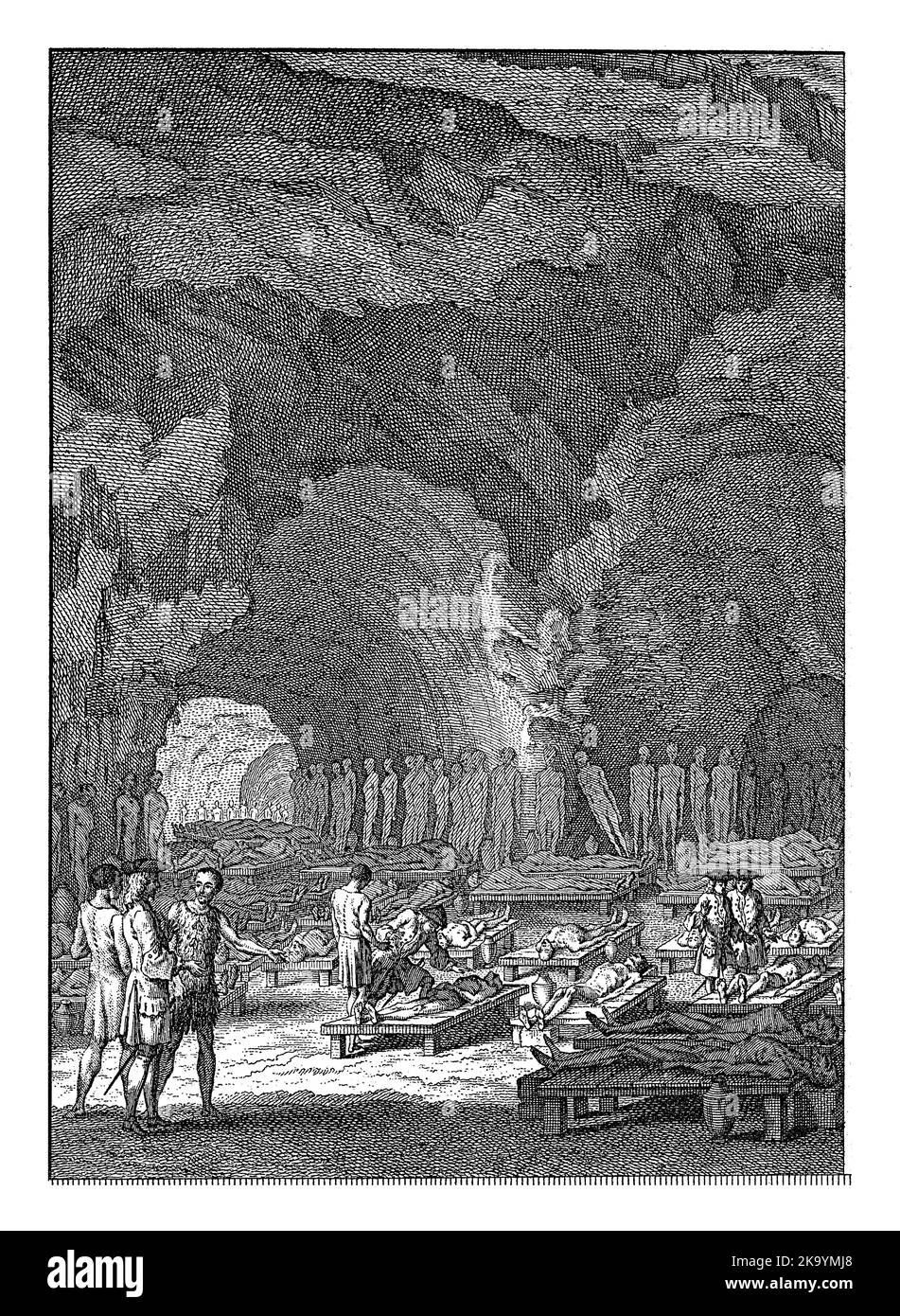 Some men look at the tomb with mummies of the original inhabitants of