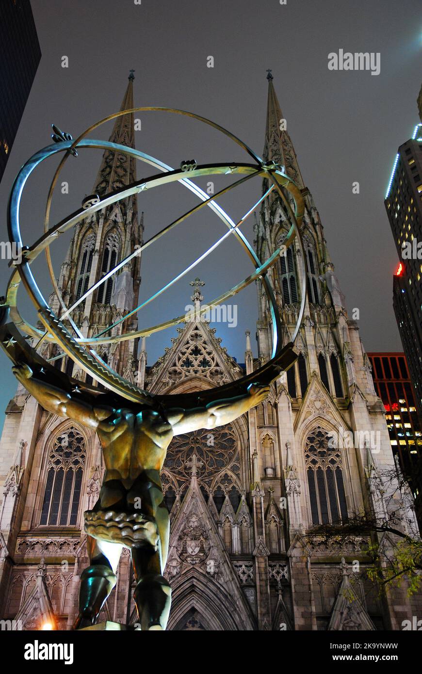 A sculpture of Atlas in Rockefeller Center Stands Strong in Front of St Patrick's Cathedral, New York Stock Photo