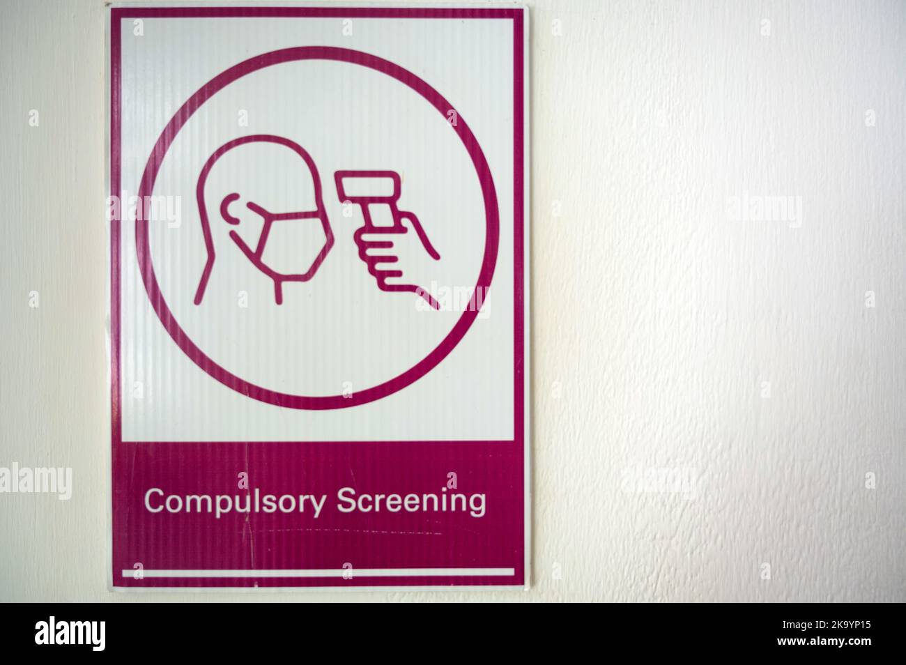 View of sign compulsory screening, close-up photo with white background ...